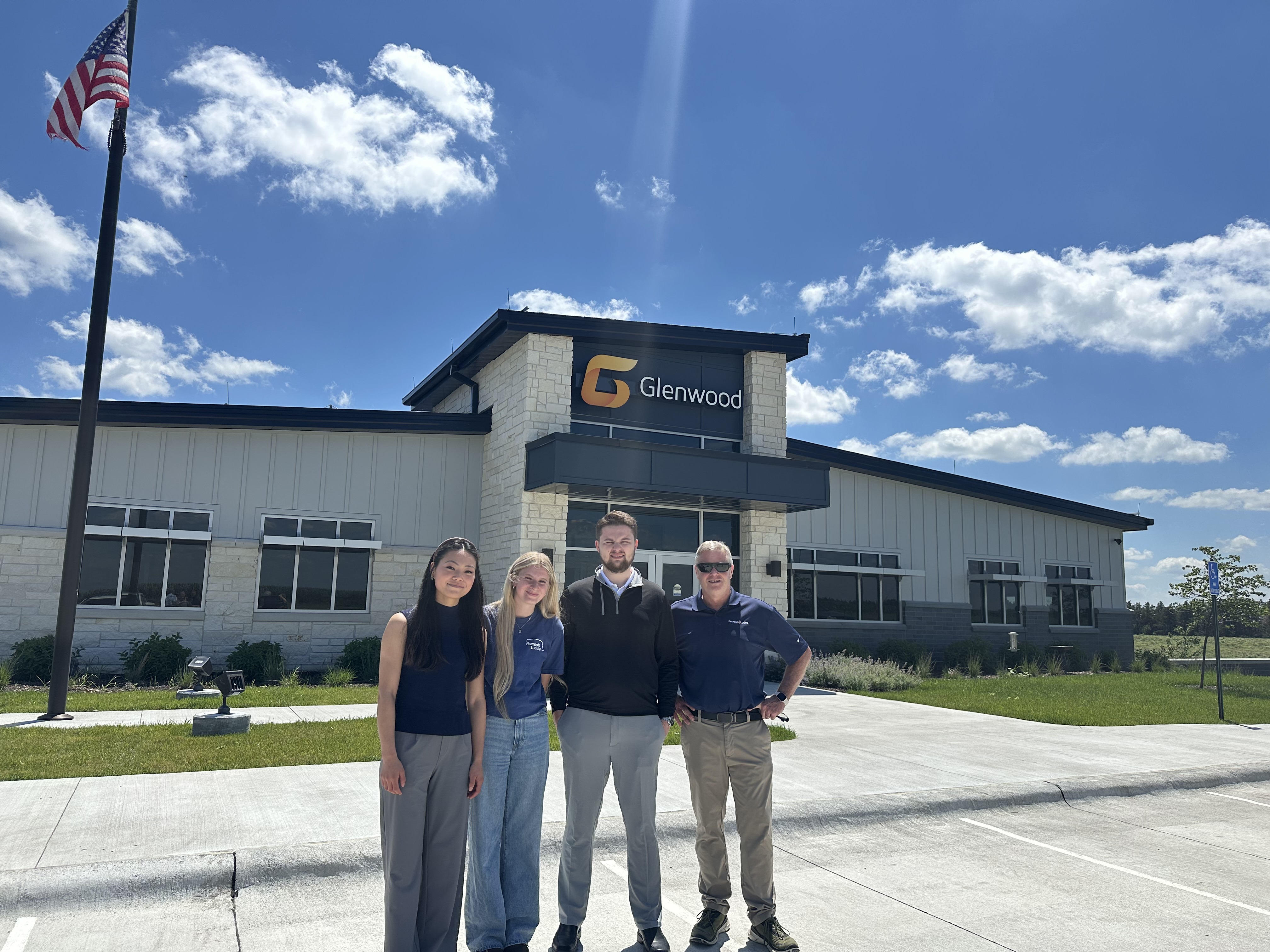 Rembolt Ludtke Summer Associates standing in front of the Glenwood building
